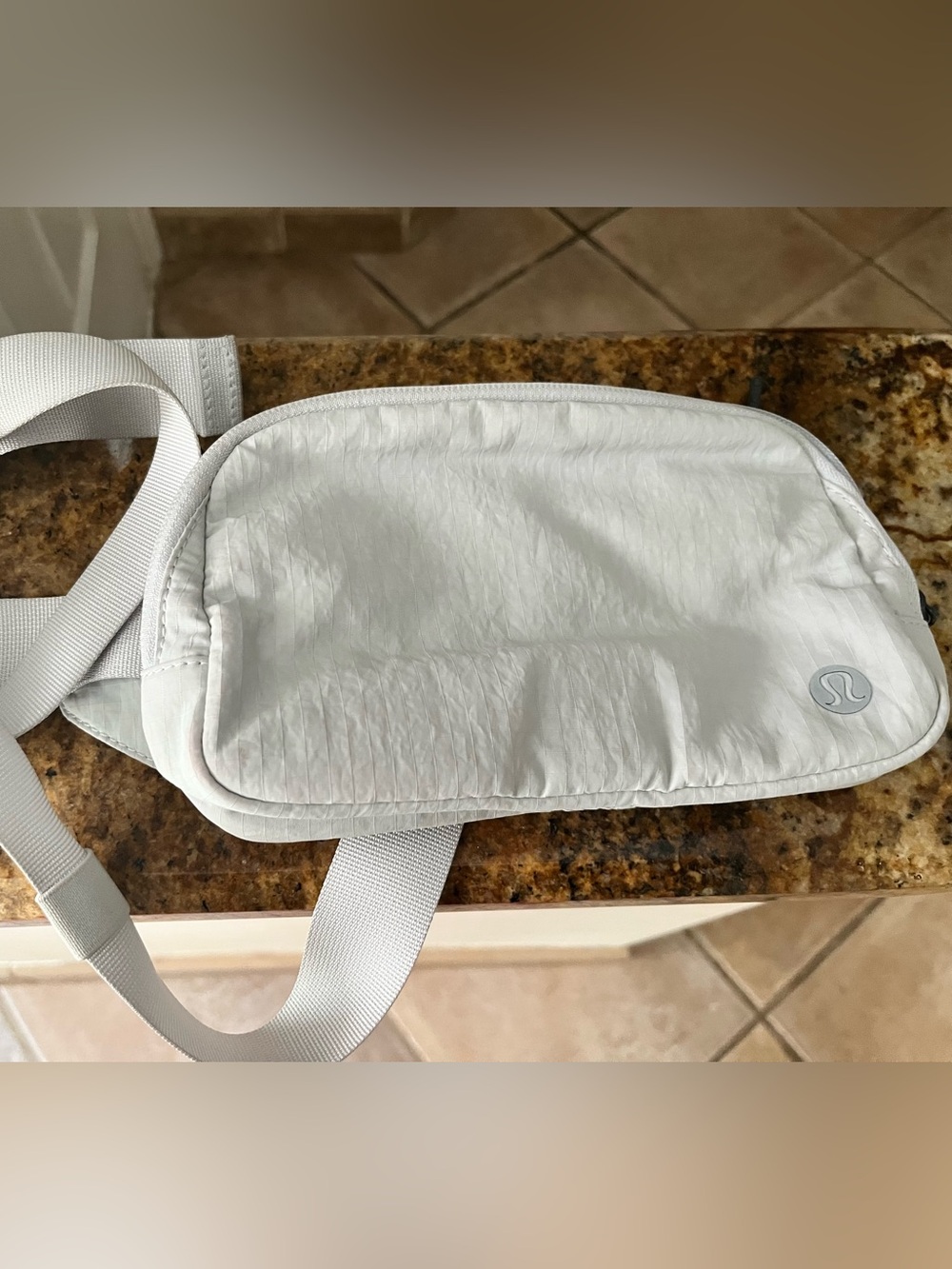 Excellent Condition Lululemon crossbody bag light gray color.